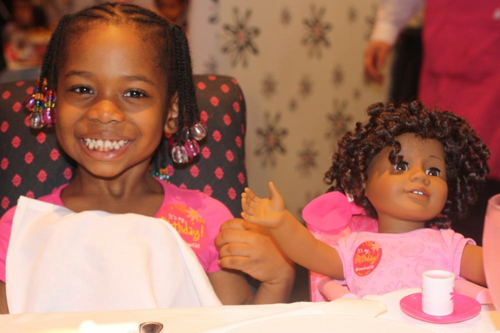 Little Black girl and her American Girl doll at American Girl Place