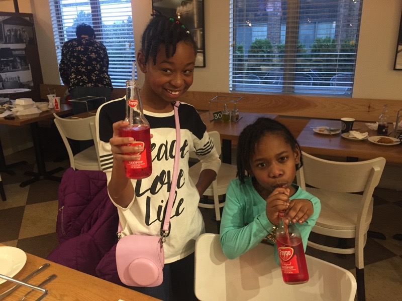 Little girls drinking Faygo Pop.